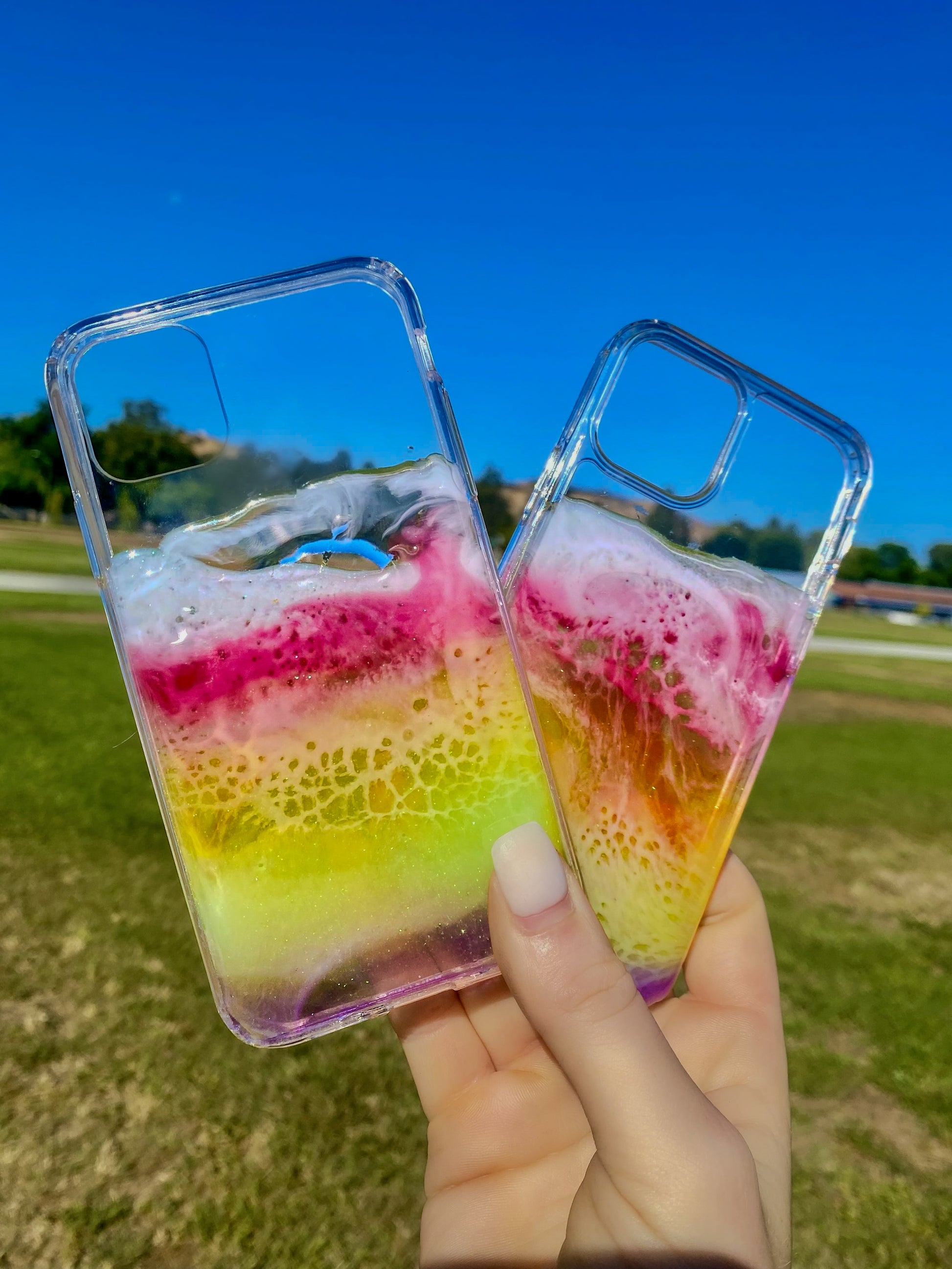 Transparent rainbow resin ocean wave iPhone cases.