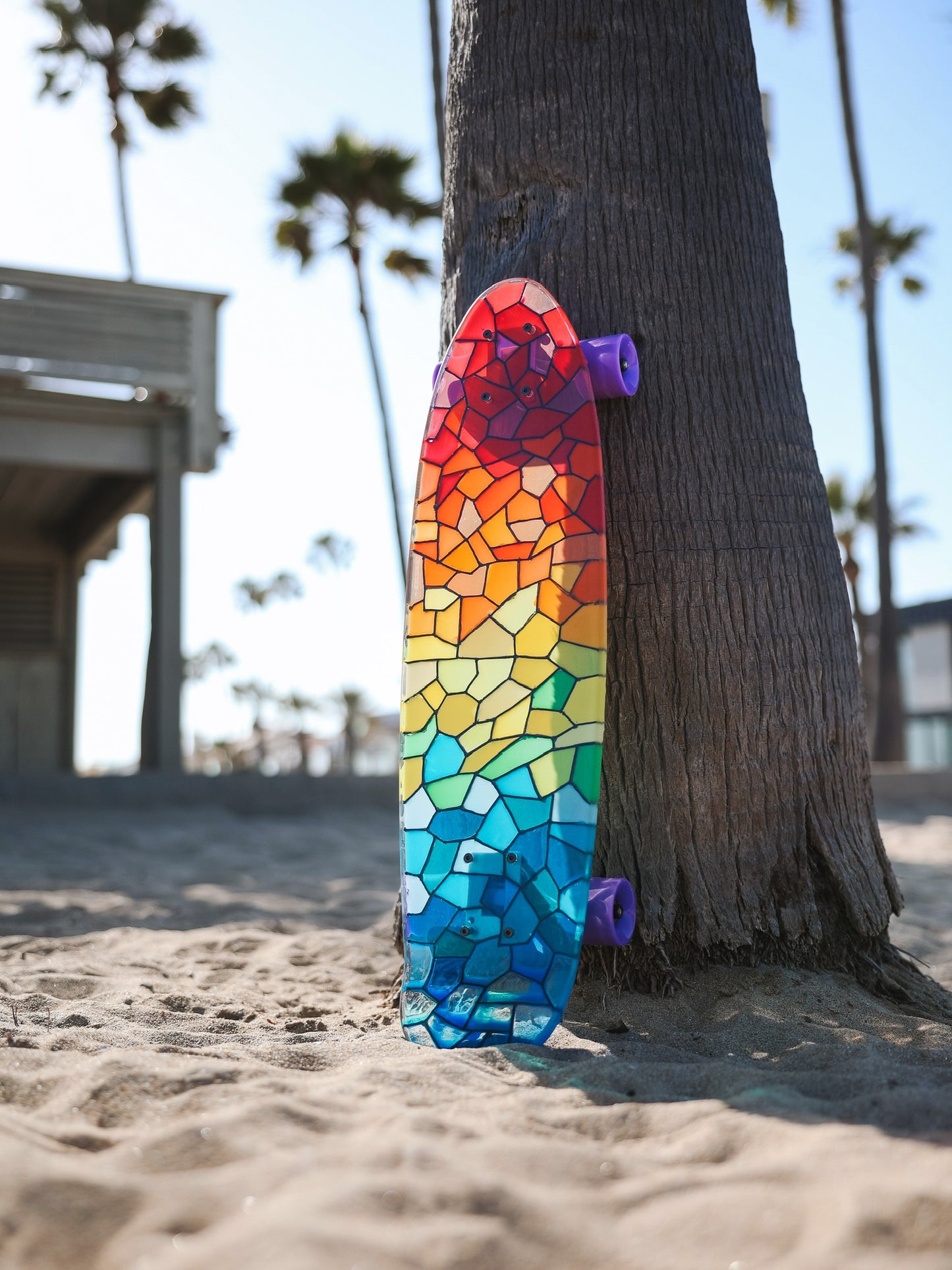 See-through rainbow stained glass skateboard with colorful shadow.