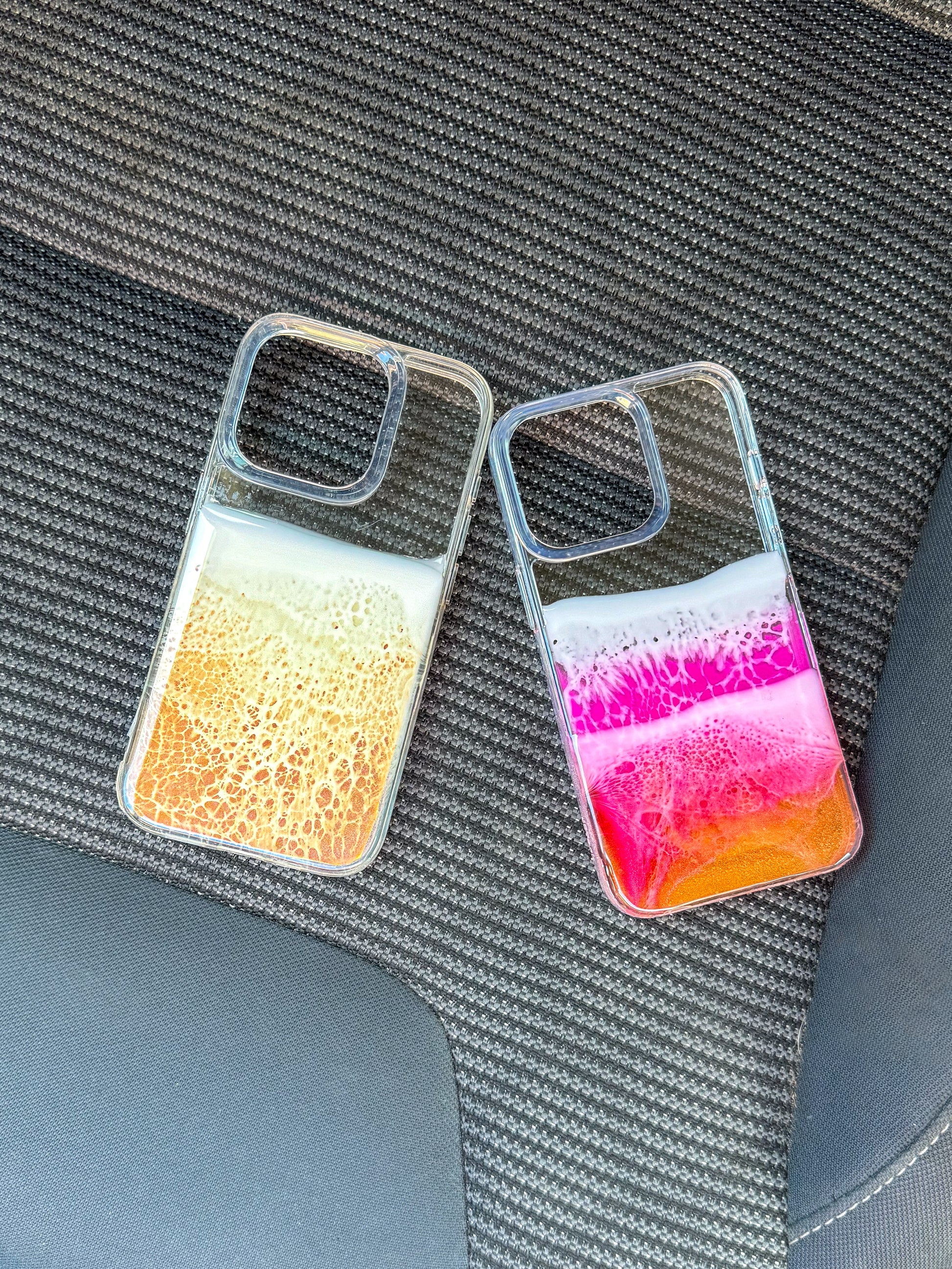 Pink, red and orange see-through resin ocean wave iPhone case.