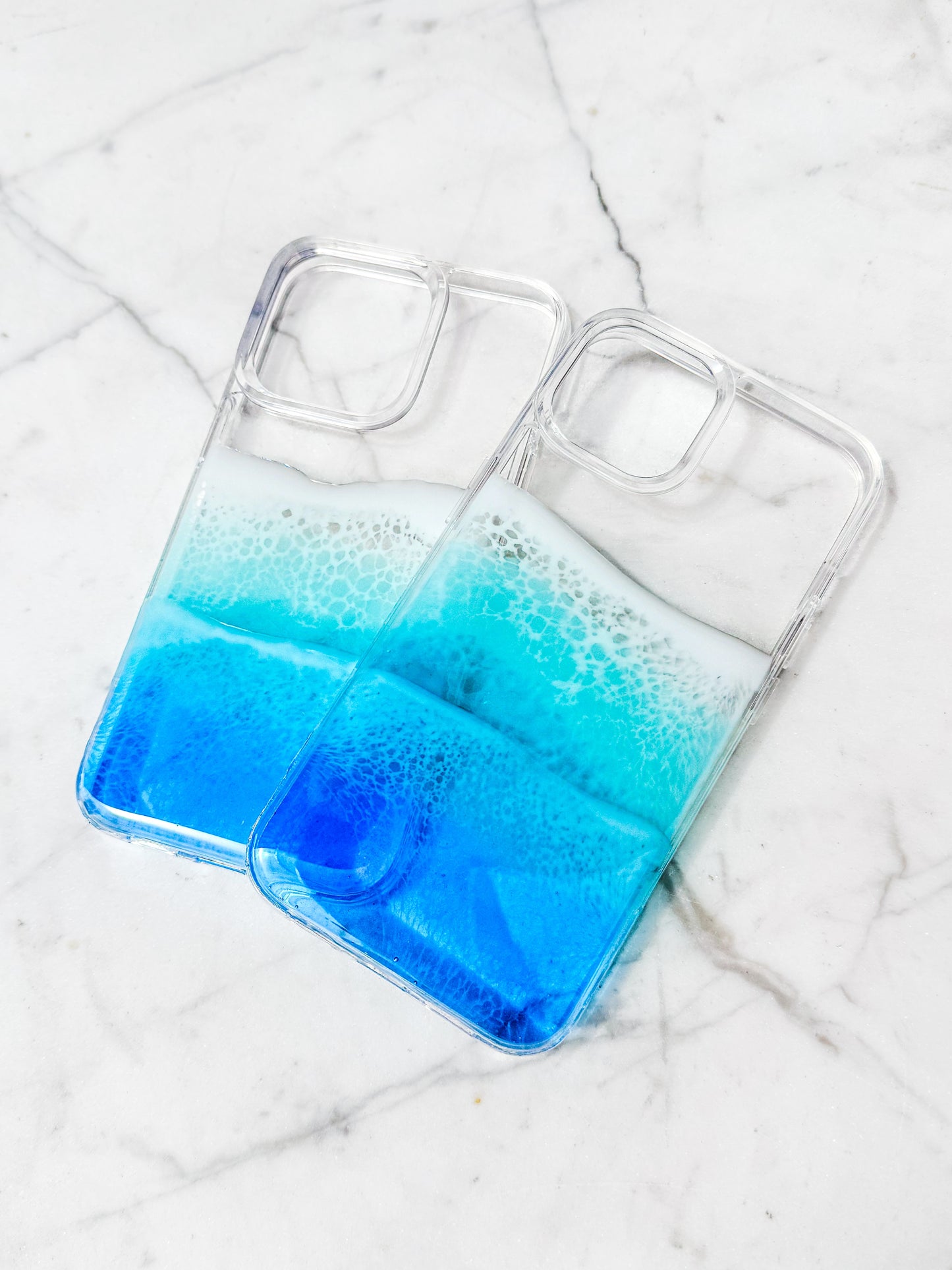 Blue resin ocean wave iPhone case casting colorful shadow.