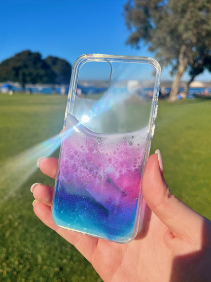 See-through blue, purple, and pink ocean wave iphone case.