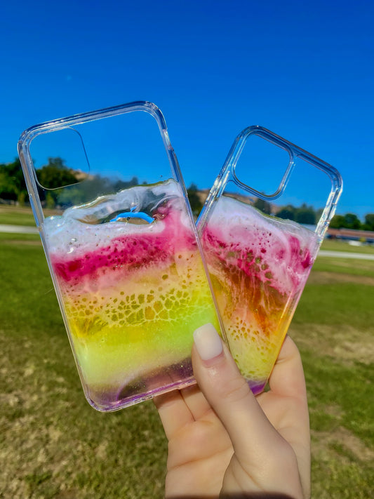 Transparent rainbow resin ocean wave iPhone cases.