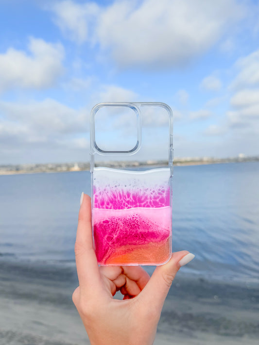 Pink, red and orange see-through resin ocean wave iPhone case.